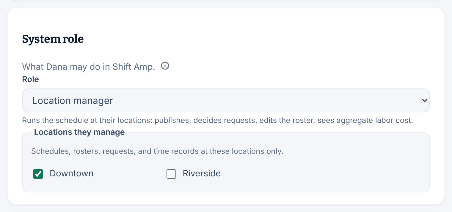 The System role panel for Dana Brooks, with Location manager chosen as the role, its description underneath, and Downtown ticked under Locations they manage.
